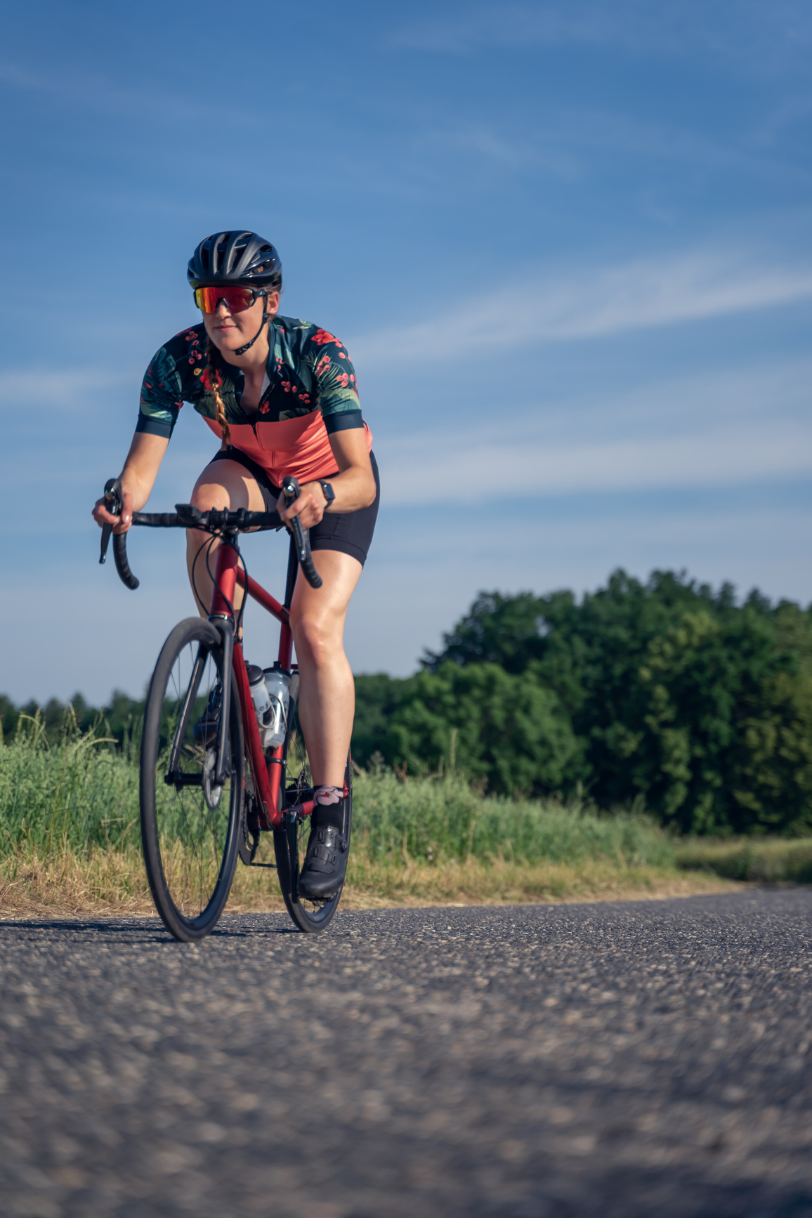 Women Cyclist in Action riding down gravel road